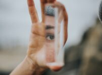 shallow focus of person holding mirror