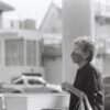 woman in black long sleeve shirt standing beside white table