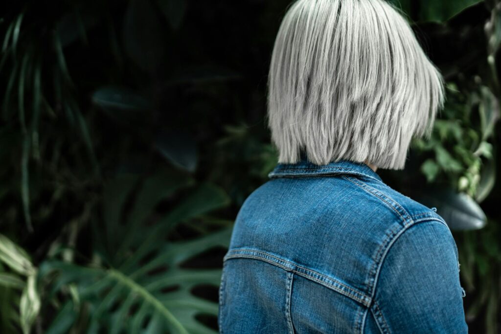 person wearing blue denim jacket