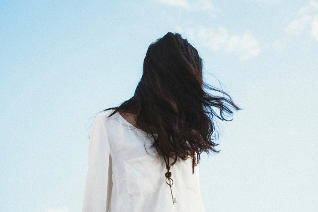 black hair swept away wind