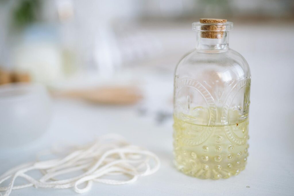 clear glass bottle with liquid inside